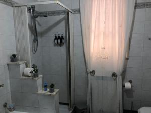 a bathroom with a shower with a shower curtain at Donna Teresa in Castelbuono +7 photos