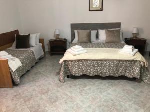 a bedroom with two beds and two night stands at Donna Teresa in Castelbuono