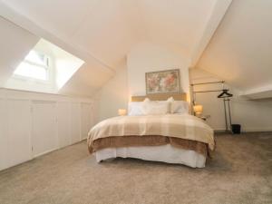 a bedroom with a large bed in a attic at Broad Beams in Neston