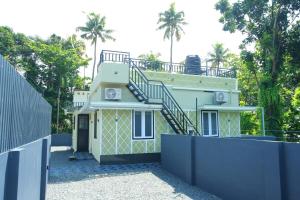 a house with a staircase on top of it at AJ Homes - Aaron Villa in Ernakulam