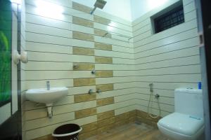 a bathroom with a sink and a toilet at AJ Homes - Aaron Villa in Ernakulam +21 photos