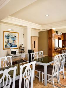 a dining room with a table and white chairs at Hotel Bresciani in La Aurora