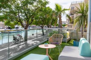 a balcony with a view of the water and trees at Hotel Majorca in Gabicce Mare
