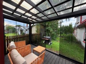 a screened in porch with a pergola at Pärnu Summer Studio in Pärnu