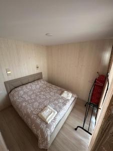 a small bedroom with a bed in a room at EL House in Karakol