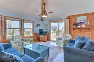 a living room with two couches and a tv at 5070 - Sandy Bottoms in Kill Devil Hills