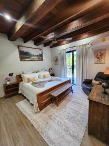 a bedroom with a large bed and a couch at Brisal Mountain Retreat in Jarabacoa