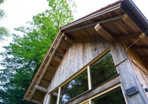 a timber clad house with large windows at Dazumahl schafft besondere Augenblicke für Genießer im naturnahen Private Hideaway in der Oststeiermark in Puch bei Weiz