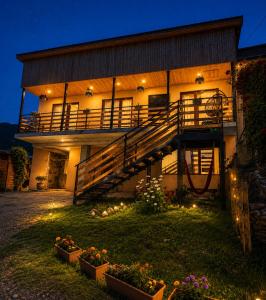 a house with a staircase in front of it at night at Relax Kazbegi Panoramic Mountain View in Kazbegi