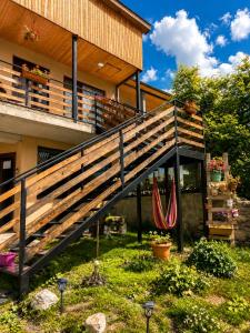 a house with a deck with hammocks in the yard at Relax Kazbegi Panoramic Mountain View in Kazbegi