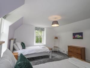 a bedroom with two beds and a window at Station Lodge in Forres