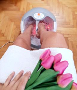 a person in a machine with pink tulips at TI-NI Apartment in Gevgelija