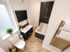 a bathroom with a toilet and a sink and a shower at Castle Chambers Serviced Apartments in Lancaster +18 photos
