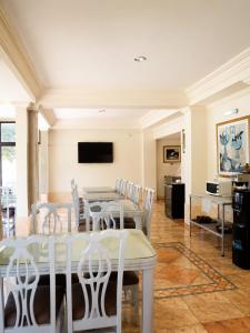 a dining room with a white table and chairs at Hotel Bresciani in La Aurora