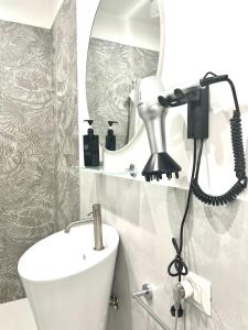 a bathroom with a sink and a mirror at La Pola House Cagliari in Cagliari +17 photos