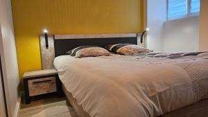 a bedroom with a bed with two pillows on it at Appartement cozy 2 chambres in Luchon