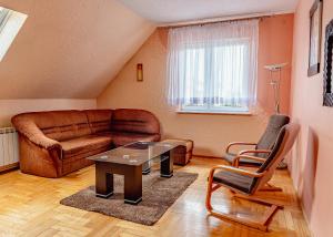 a living room with a couch and a table at MM Pokoje in Dziwnówek