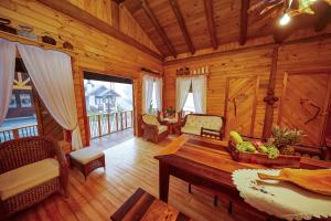 a living room of a log cabin with a table at Hospedaria Morada das Grimpas in Palmeira
