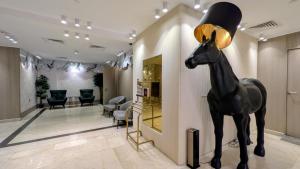 a statue of a horse in a waiting room at Al Mansour Plaza Hotel in Doha +24 photos