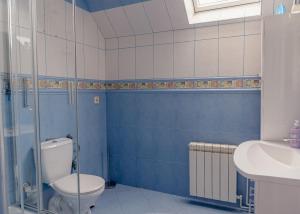 a blue and white bathroom with a toilet and a sink at MM Pokoje in Dziwnówek +25 photos