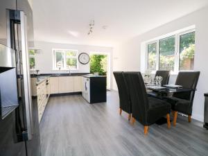 a kitchen and dining room with a table and chairs at Lucerne Cottage in Dorking