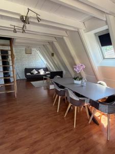 a living room with a table and chairs at Chalet 6 à 8 personnes in Drulhe
