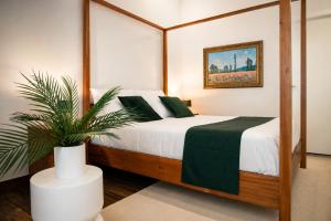 a bedroom with a bed and a potted plant at Villa Monet in Castiglione di Ravenna