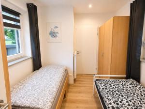 a bedroom with two beds and a window at Rent Room Vermietungen in Oberhausen