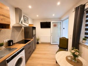 a kitchen with a sink and a stove top oven at Rent Room Vermietungen in Oberhausen