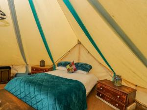 a bedroom with a bed in a tent at The Moroccan Bell Tent in Newbury