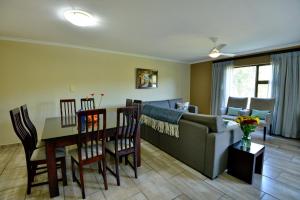 a living room with a couch and a table at Uvongo River Resort by MyResorts in Margate