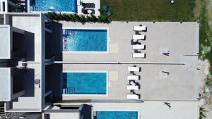 an overhead view of a building with two swimming pools at The Serata Villas in Hanioti