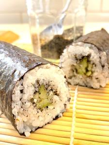 two rolls of sushi sitting on a table at O Jardin Sakura Chambres et table d'hotes sur la route du Mont Saint-Michel in Val Couesnon