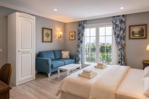 a bedroom with a bed and a blue couch at Sahil Panorama Otel in Trabzon +16 photos
