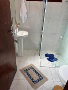 a bathroom with a shower and a sink at Casa Flora & Mar in Pipa +17 photos