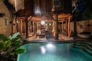 a swimming pool in a building with a house at Gili Treehouses Private Pool Hideaway in Gili Trawangan +170 photos
