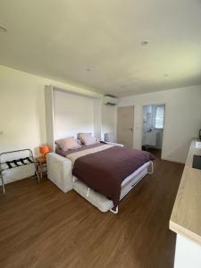 a large bedroom with a large bed in it at Studio indépendant à notre maison in Concarneau