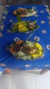 three plates of food on a blue table at FG Bungalow Bar in Ianakandrarezo