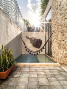 a pool with a guitar on the side of a house at Casa Bolero Santa Lucía with Parking by Cercana in Mérida