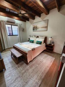 a bedroom with a large bed in a room with wooden ceilings at Brisal Mountain Retreat in Jarabacoa +59 photos