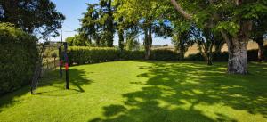 a yard with a goal in the grass with trees at Hotel La Palloza in Lugo