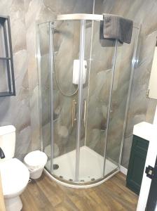 a shower with a glass enclosure in a bathroom at The Townhouse Self Catering in Dumfries