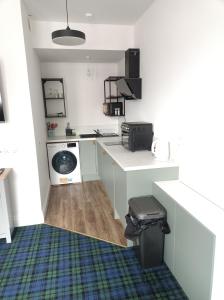 a small kitchen with a washer and dryer at The Townhouse Self Catering in Dumfries