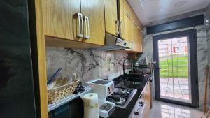 a kitchen with wooden cabinets and a stove top oven at Bungalow in Tangier in Tangier