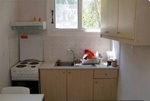 a kitchen with a sink and a stove at Poraika studios in Raches