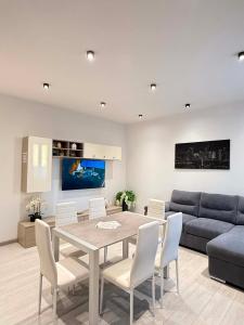 a living room with a table and a couch at B&B Legnago in Legnago