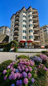 a large building with flowers in front of it at Borahan Hotel in Trabzon