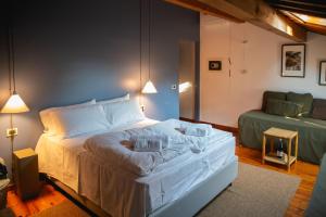 a bedroom with a white bed with two pillows at Locanda Hemingway in Bassano del Grappa