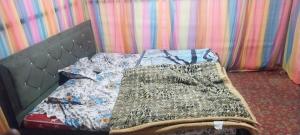 a bed with a quilt on it in a room at eco friendly camping site pahalgam in Pahalgām