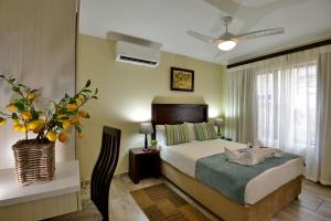 a hotel room with a bed and a window at Uvongo River Resort by MyResorts in Margate +33 photos